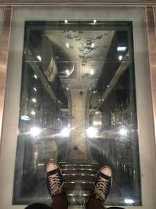 A glass floor looking down from deck 14 to the Royal Esplanade on Deck 4 on Quantum of the Seas