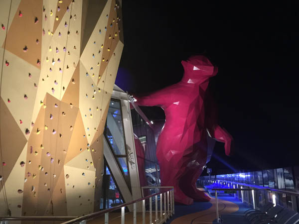 The $6M purple bear on Quantum of the Seas lit up at night.