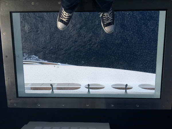 Glass floor on one of the Quantum of the Seas bridge wings looking 14 stories down to the sea