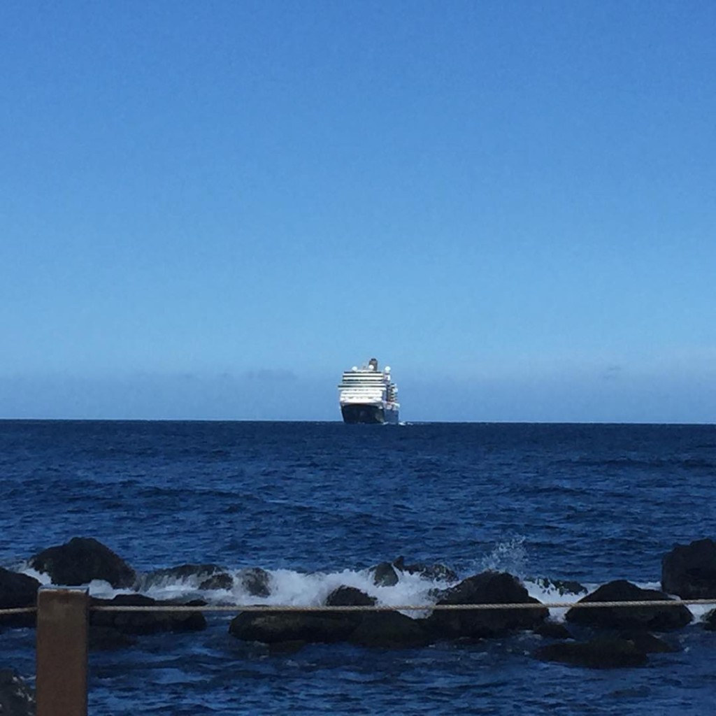 Off in the distance, the Holland America Line ship, Nieuw Amsterdam, begins to make her way into the San Juan Harbour