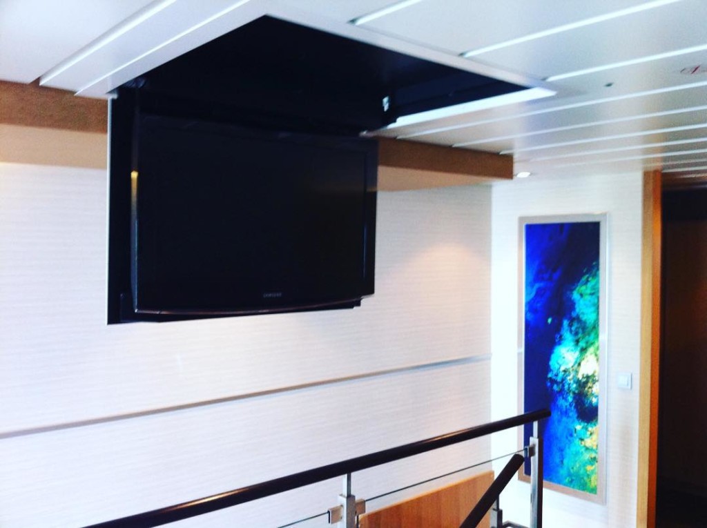 Flat screen TV comes out of the ceiling in the Master Bedroom of the Crown Loft Suite 1710 on Royal Caribbean's Allure of the Seas