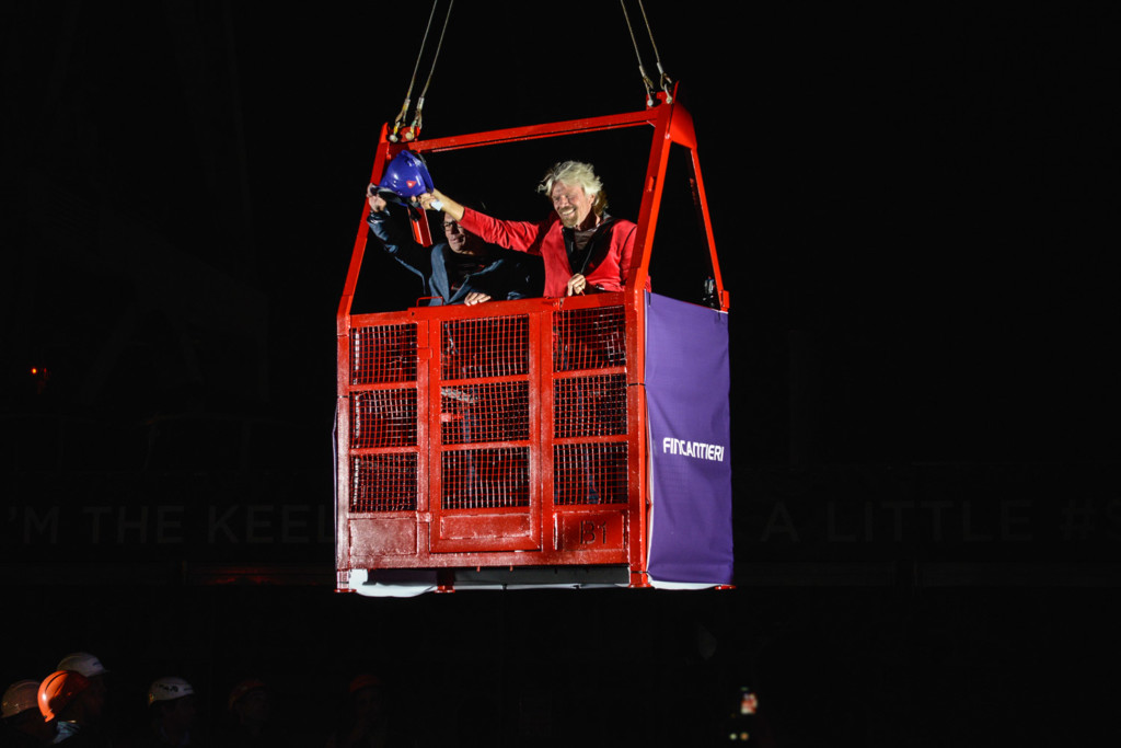 Sir Richard Branson arrives in a construction cage for the keel-laying ceremony of Virgin Voyages first cruise ship.