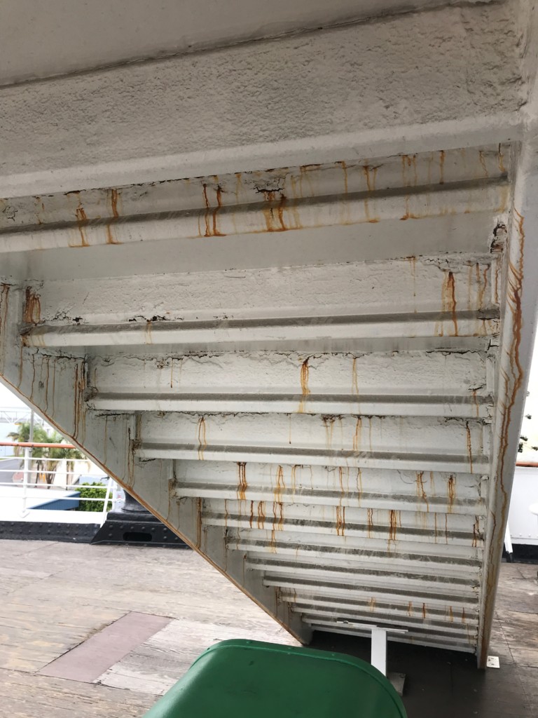 The underside of a stairway located on the stern of the Queen Mary that can use some TLC