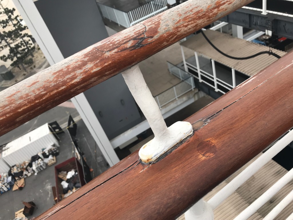 A look at the wood railing on the port side Sun Deck of the Queen Mary that has been left unvarnished and in a state of disrepair