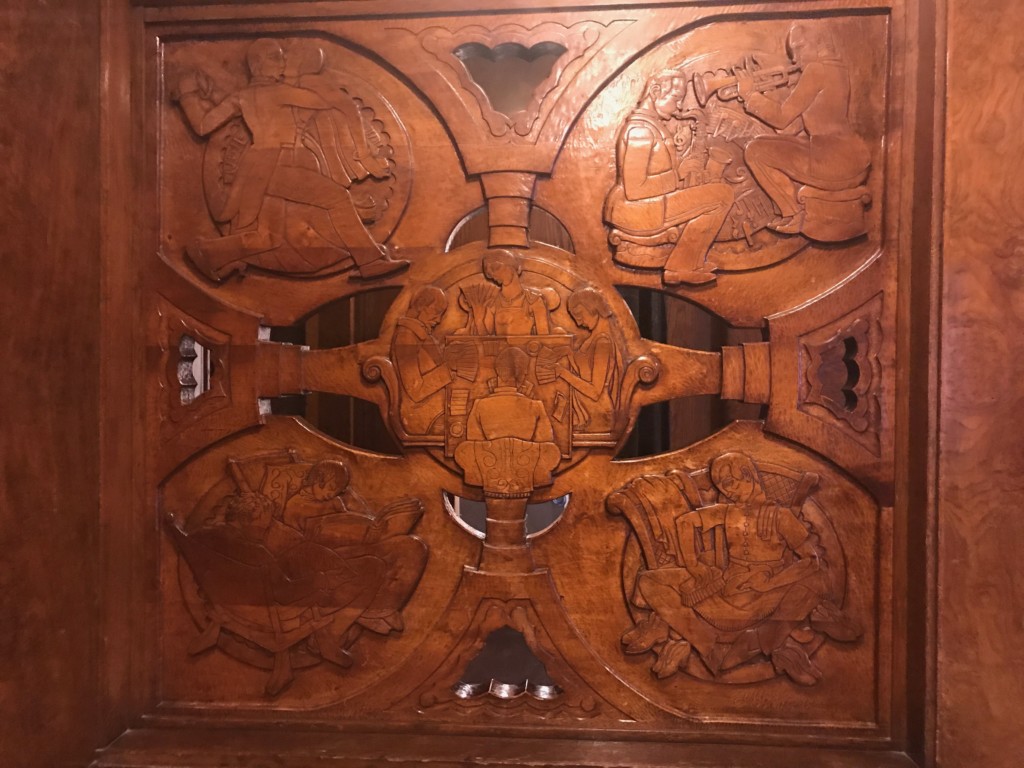 Some carvings in the wood paneling that lines the walls in the Queen Mary's Royal Salon