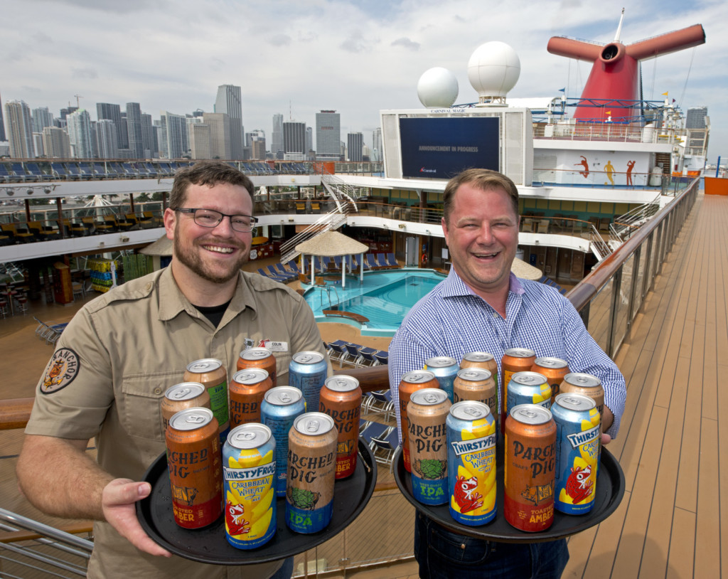 Colin Presby, left, Carnival Cruise Line’s brewmaster, and Edward Allen, right, Carnival’s vice president of beverage operations show trays of the line’s new craft beer cans.