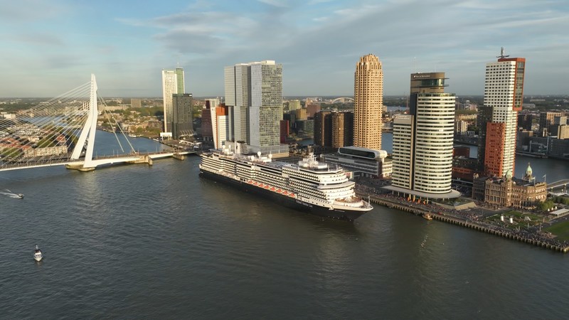 Holland America Line's Rotterdam VII departed the city of Rotterdam, the Netherlands, today on its historic 150th Anniversary Transatlantic Crossing. The 15-day journey recreates Holland America Line's maiden voyage of Rotterdam I that departed the city 150 years ago today. The crossing follows the path of that first sailing to New York, with calls at Le Havre, France, and Plymouth, England. The brick building with towers in the lower right is the former headquarters for Holland America Line and is now Hotel New York.