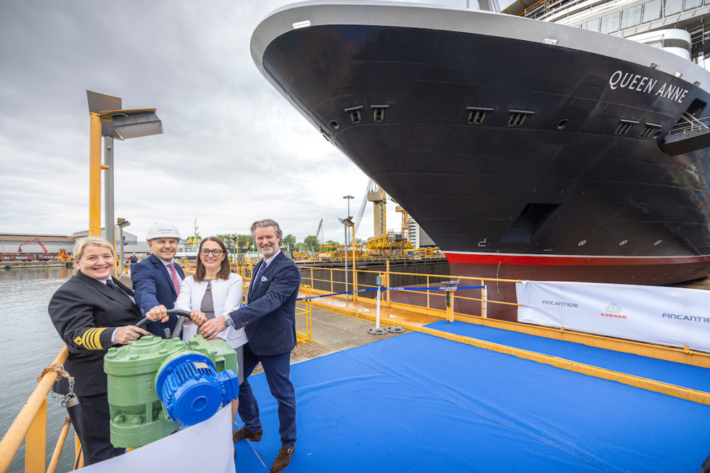 Captain Inger Klein Thorhauge, Marco Lunardi, shipyard Director, Roberta Mundula and Sture Myrmell, Carnival UK President in front of the newest ship, Queen Anne, at the Fincantieri Marghera shipyard in Venice, Italy.