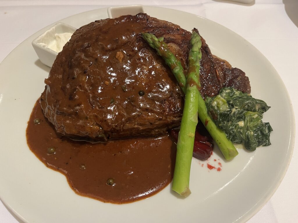 Pinnacle Grill Ribeye served in the main dining room on Holland America's Rotterdam