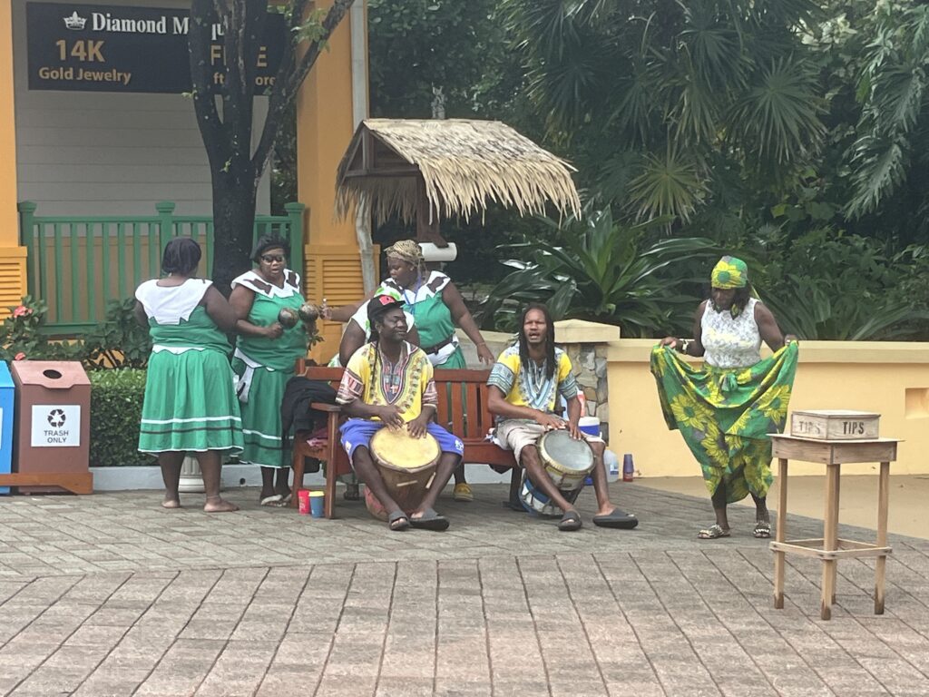 Locals entertain at the entrance to Mahogany Bay