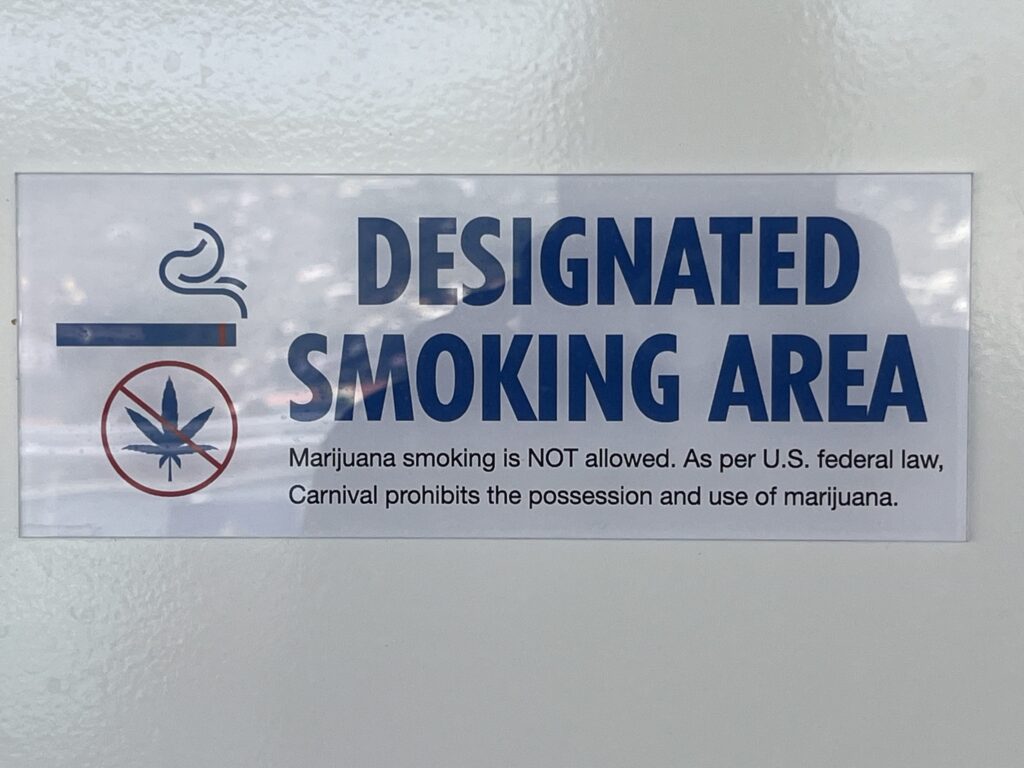 Designated Smoking Area sign on Carnival Celebration clearly points out that marijuana is not permitted to be smoked onboard.