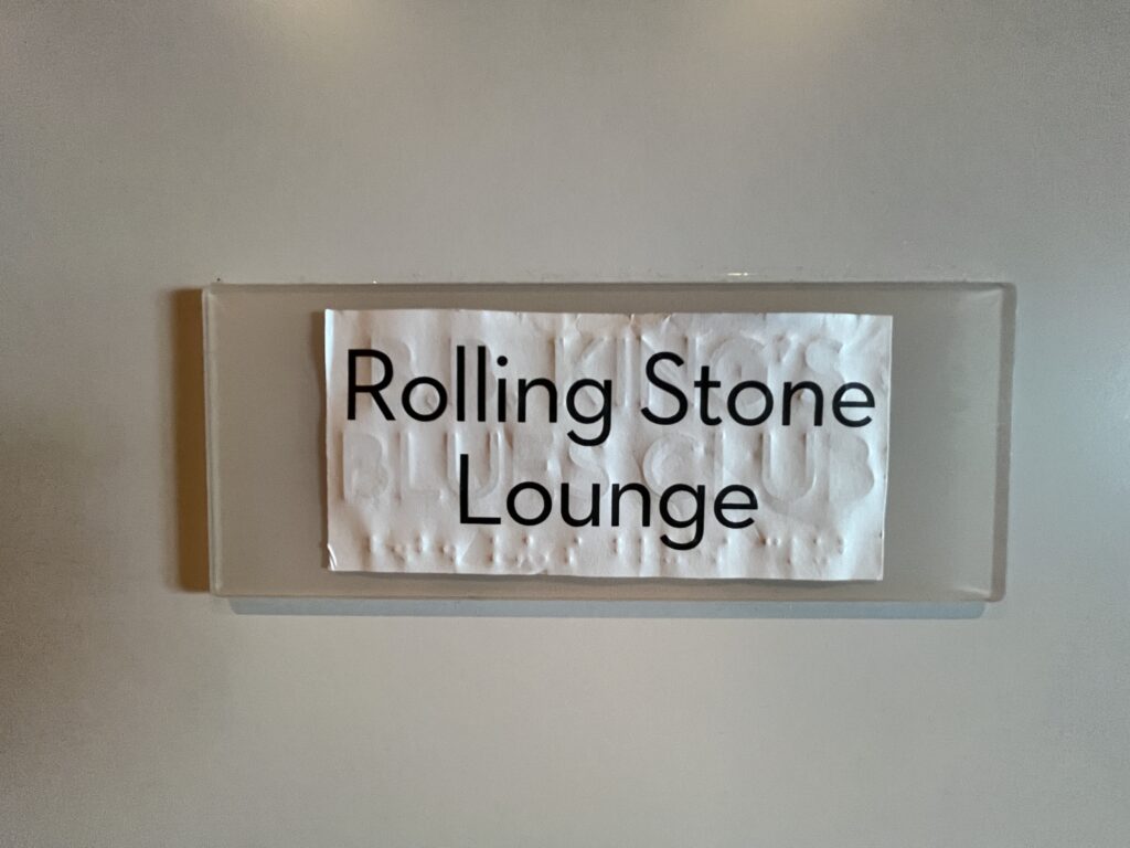 Slap a sticker on it! A cheap and tacky sign for the Rolling Stone Lounge