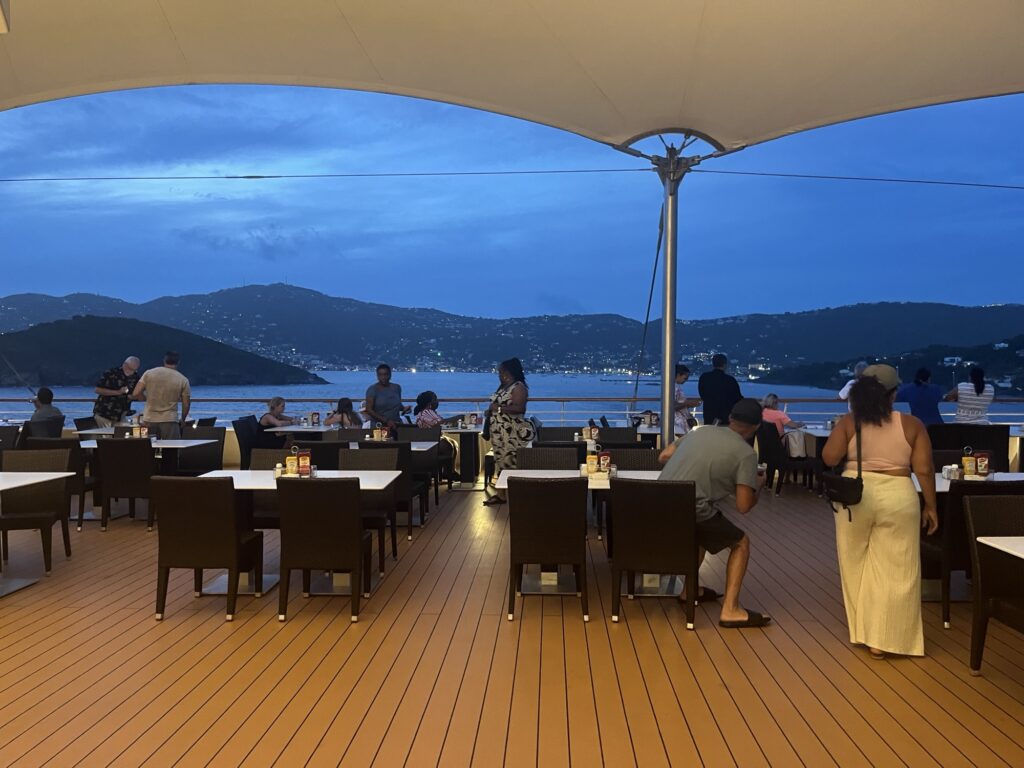 Outdoor dining area and bar on Norwegian Sky