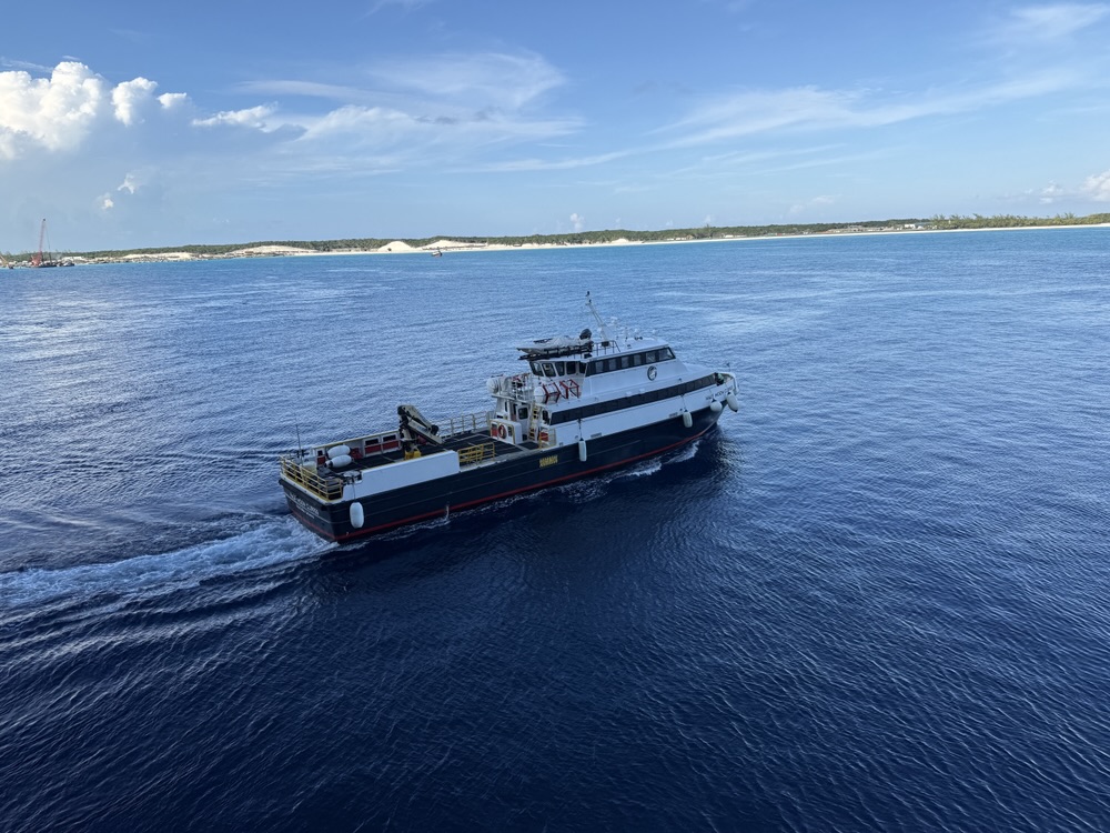 Supply boat heading back to the island after returning supplies to the ship