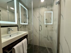 Bathroom with shower and sink in Family Oceanview Stateroom 1028 on Rotterdam