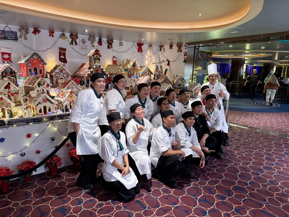The Rotterdam's Pastry Team in front of their gingerbread house display