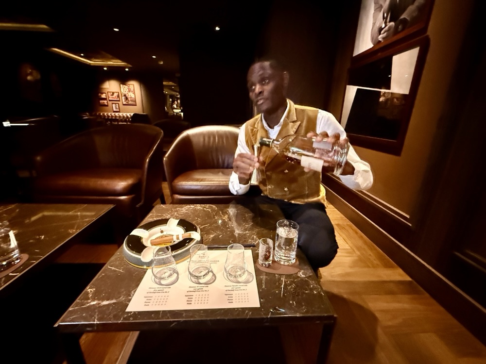 Emmanual pouring some cognac during Cognac and Cigars on Explora I