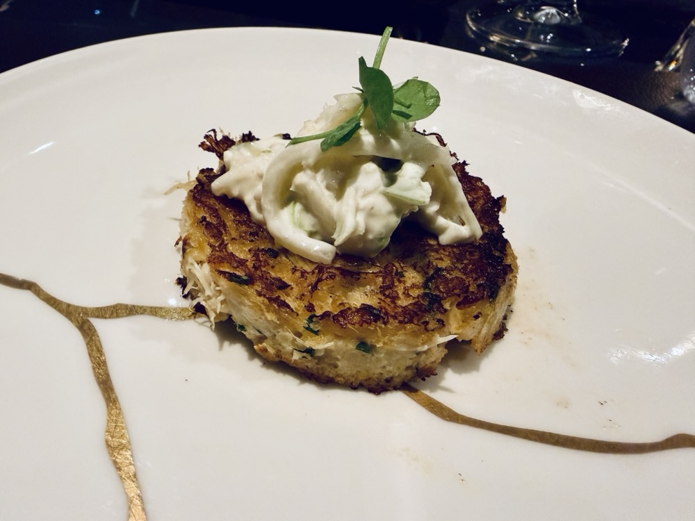 Blackened crab cake from Marble & Company Grill on Explora Journeys