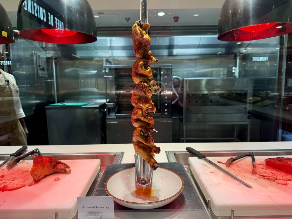 Roast chicken on display at the Emporium Marketplace on Explora Journeys