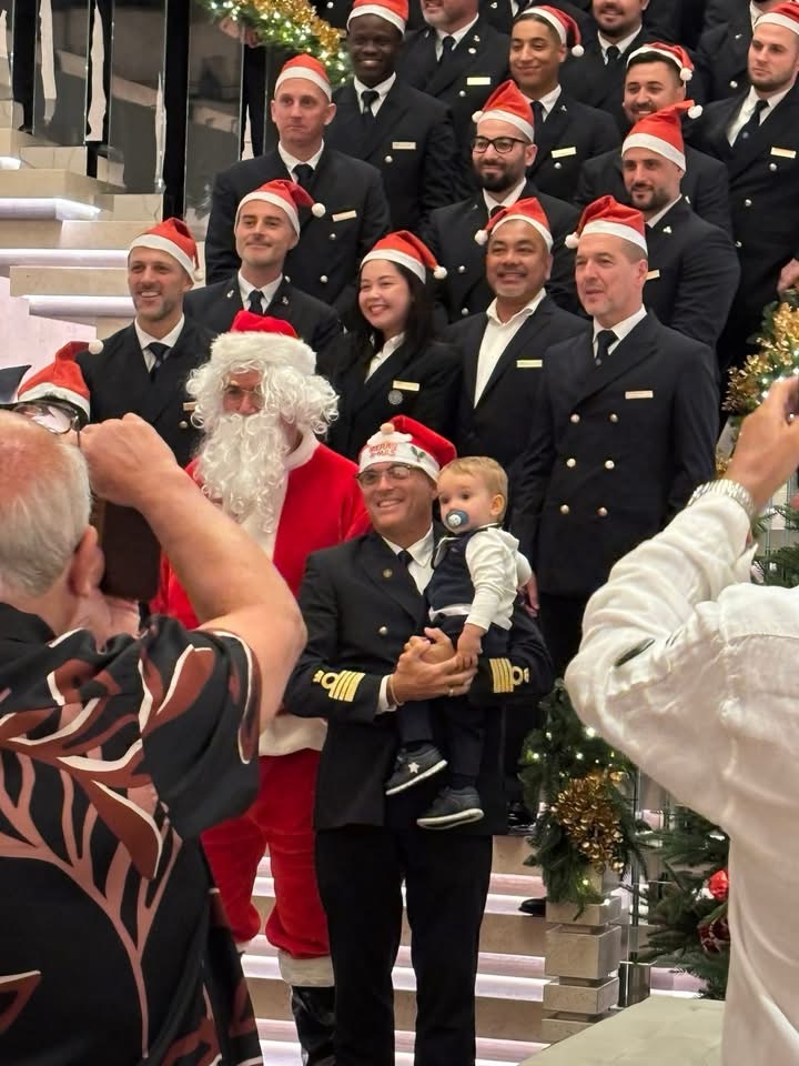 Explora I's captain and crew along with Santa singing Christmas carols