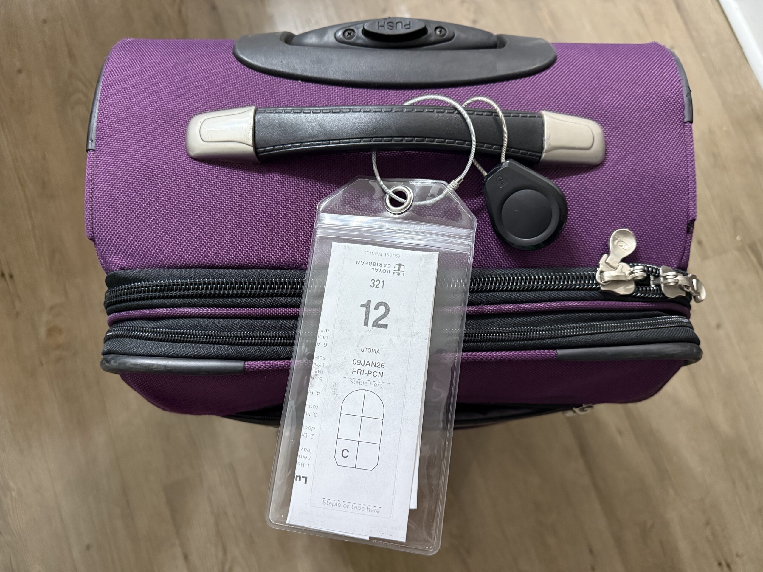 Plastic luggage tag holder with Royal Caribbean luggage tag